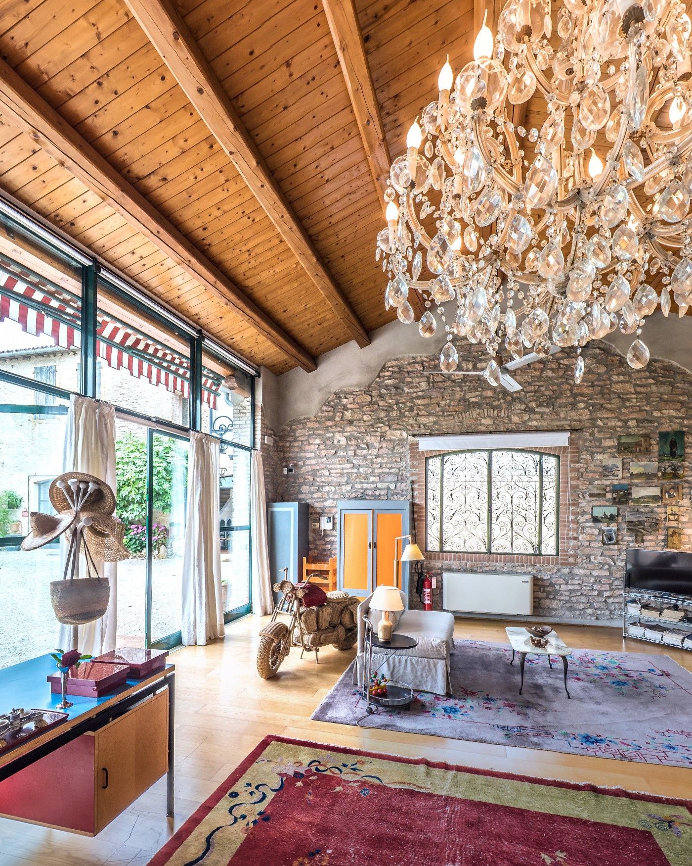 A crystal chandelier under the timber roof of the Loft