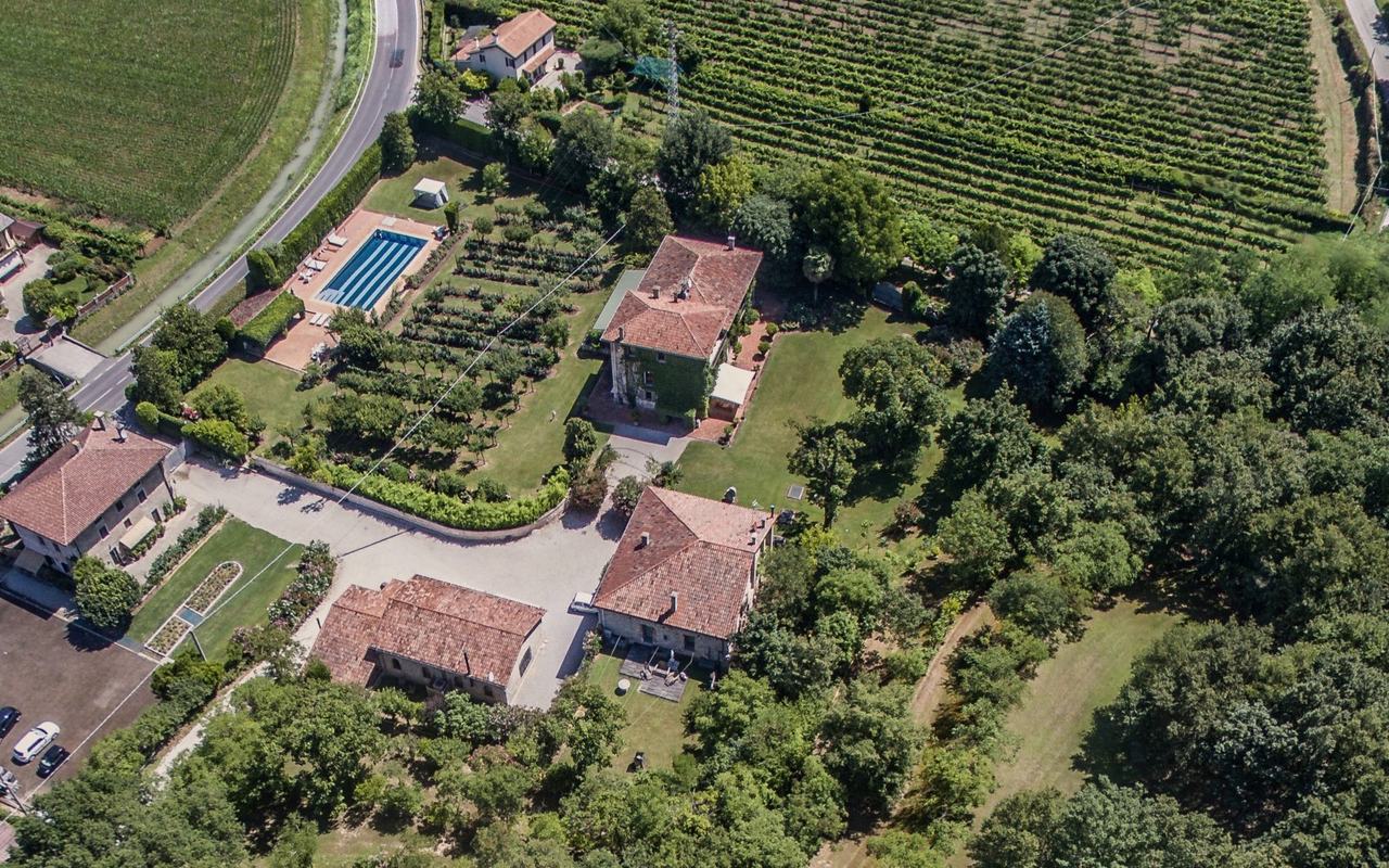 The estate from above: the villa with its ivy front, the other houses, the pool and the park